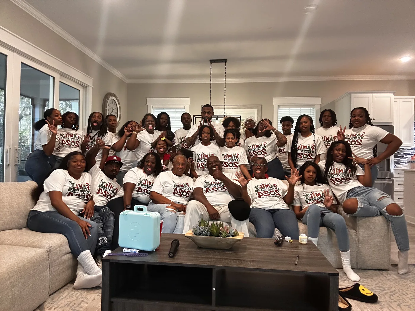 A large family group in matching Family Christmas 2024 shirts, made by ABAC