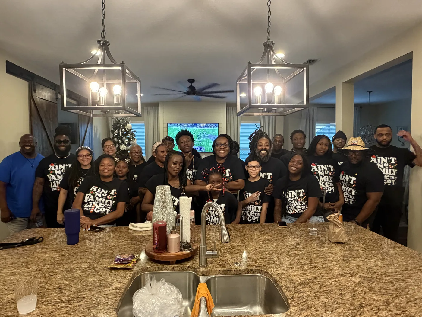 A whole family in matching Ain’t No Family Like The One I Got shirts, made by ABAC